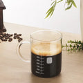 Casora glass coffee server with scale markings filled with coffee
