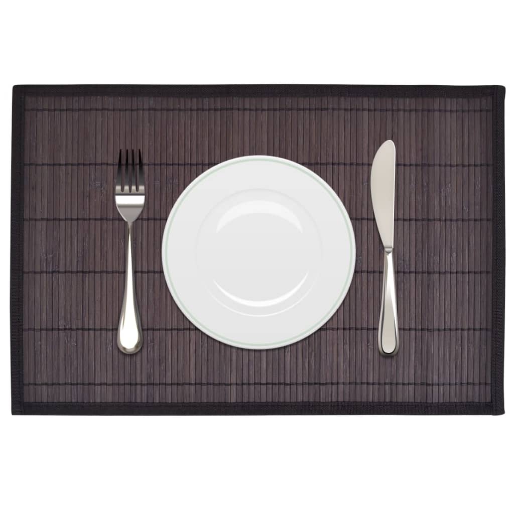Dark brown bamboo placemat with plate and cutlery on a set dining table