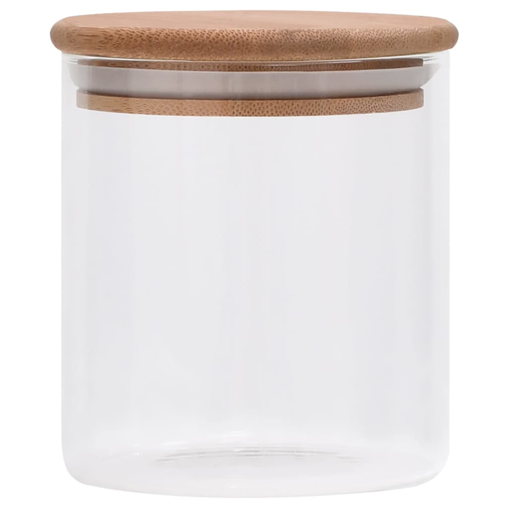 Glass storage jars with bamboo lids in kitchen setting